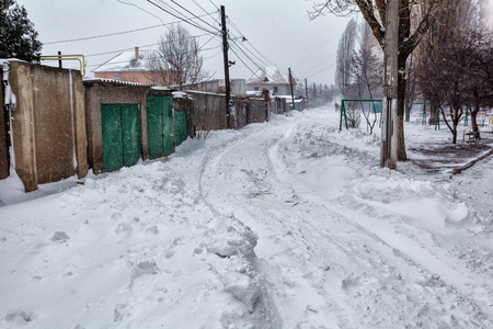 Snow storm hits town. Street after snow blizzardの写真素材