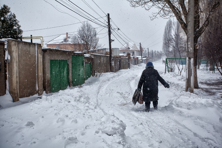 Snow storm hits town. Street after snow blizzardの写真素材