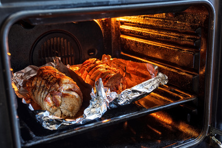 Roasted pork roll stuffed with vegetables in the oven trayの写真素材