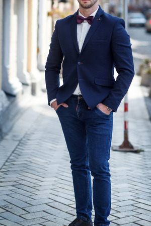 bearded man in a blue jacket and a bow tieの写真素材