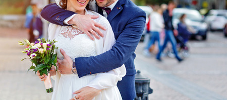 Wedding couple is hugging each other. bouquet in brides handの写真素材