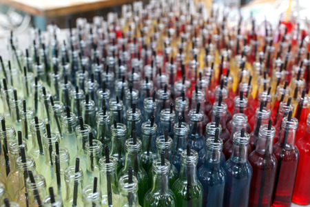 Colorful cocktails, shots with straws in small glass bottles. Row of many lemonade drinksの写真素材