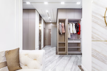 Modern built in wardrobe with closet. Assortment of Russian fur coatsの写真素材