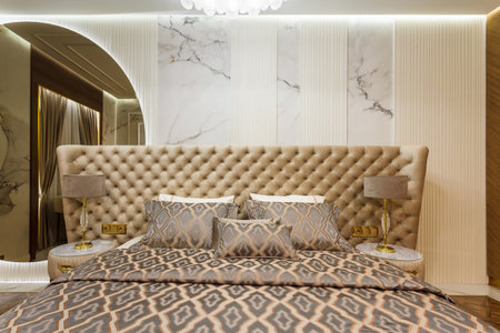Luxury Interior Primary Bedroom Detail of Headboard and Bedding.