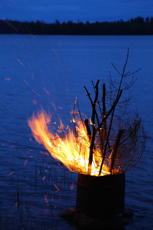 Midsummer bonfire at lakesideの写真素材