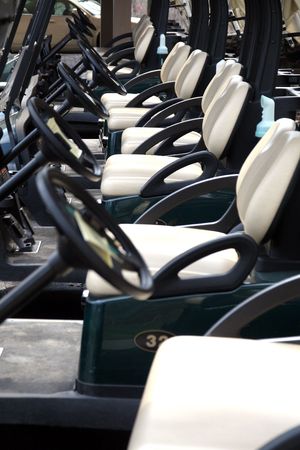 Electric golf carts standing in lineの写真素材