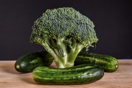 Broccoli and three green picklesの写真素材