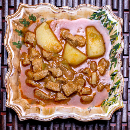 Pork stew with potatoes on plateの写真素材