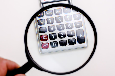 Calculator numbers under loupeの写真素材