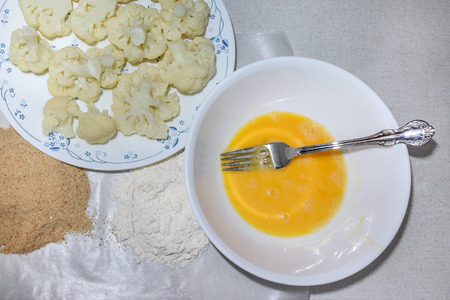 Mixed egg with fork inside plateの写真素材
