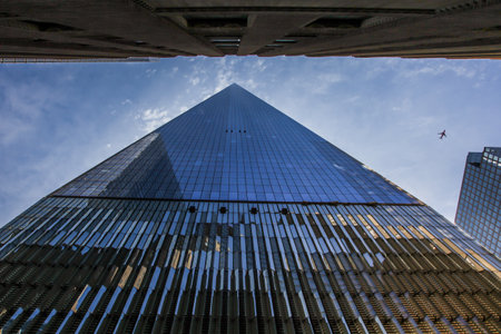 New York, CT, USA. 16th April, 2015.One World Trade center building with other buildings and blue sky with aeroplane  in NYC seen  in New York City , USA on April 16, 2015のeditorial素材
