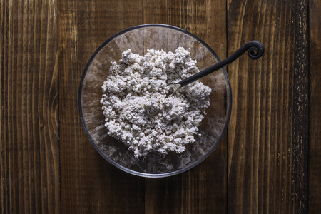 Farmers cheese mixed with cinnamon powder in glass bowlの写真素材