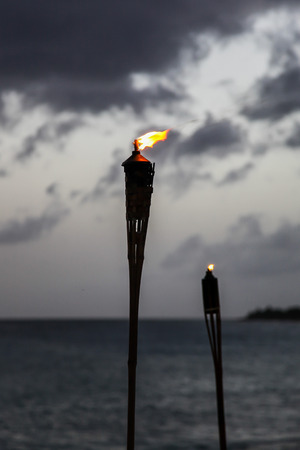 Evening with torch on beachの写真素材