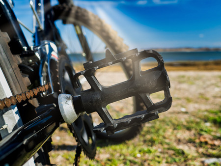 Bike pedal detail with sun beams