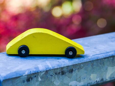 Yelloe wooden toy car with seasonal colorsの写真素材