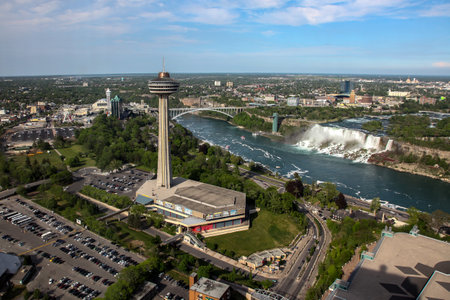 NIAGARA FALLS, ONTARIO, CANADA - MAY 27, 2016: Niagara Falls with a view of the Americans side from Ontario, Canada with Skylon Tower seen in Niagara Falls on May  27, 2016.のeditorial素材