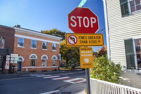 WOODSTOCK, VT, USA - OCTOBER 9, 2020: Sign near Central Street and Elm stret with morning autumn lights and blue sky in Covid-19 pandemicのeditorial素材