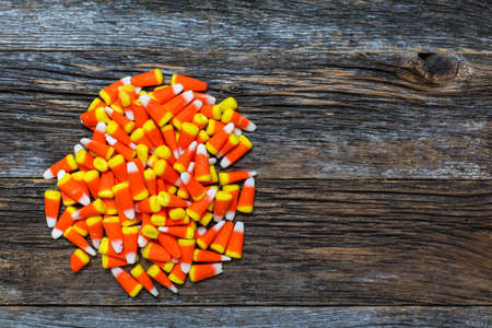 Corn candy on wooden rustic looking wooden background tableの写真素材