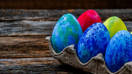 Painted easter eggs on wooden table with copy space