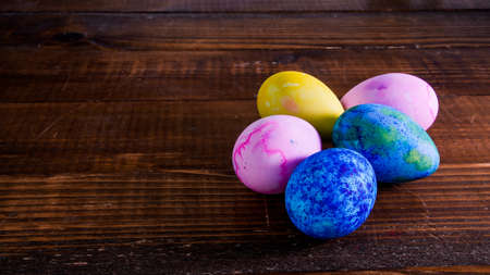 Painted easter eggs on wooden table with copy spaceの写真素材