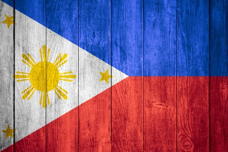 flag of Philipines or white, yellow, blue and red Philippine  banner on wooden backgroundの写真素材