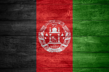 flag of  Afghanistan or Afghan banner on wooden backgroundの写真素材