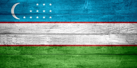flag of Uzbekistan or Uzbek banner on wooden backgroundの写真素材