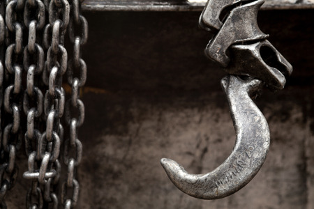 strong iron hook and metal chain on abstract rough pattern backgroundの写真素材