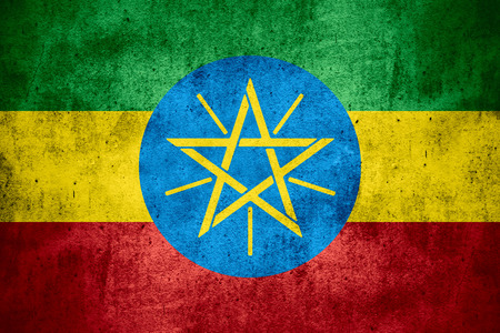 flag of Ethiopia or Ethiopian banner on rough pattern texture backgroundの写真素材