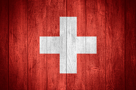 Switzerland flag or Swiss banner on wooden boards backgroundの写真素材
