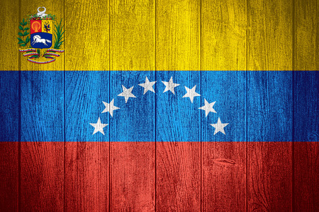 Venezuela flag or Venezuelan banner on wooden boards backgroundの写真素材