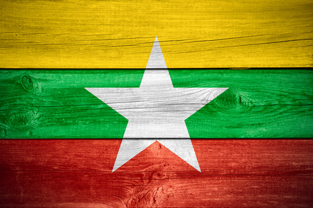 flag of Burma or Burmese banner on wooden background, Myanmarの写真素材