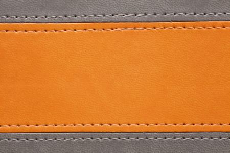 orange and grey leather texture with seam at marginsの写真素材