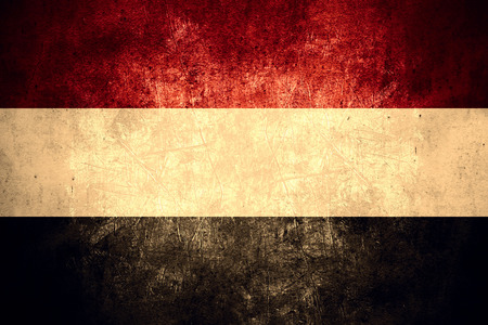 flag of Yemen or Yemeni banner on rough pattern texture vintage backgroundの写真素材