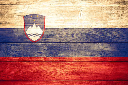 flag of Slovenia or Slovenian banner on wooden backgroundの写真素材
