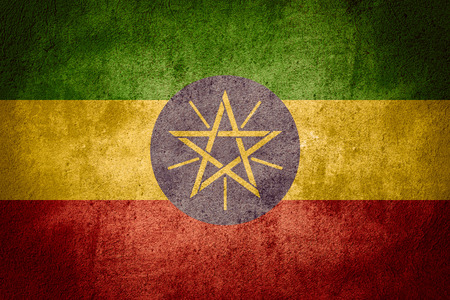 flag of Ethiopia or Ethiopian banner on rough pattern backgroundの写真素材