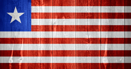 flag of Liberia or Liberian banner on wooden backgroundの写真素材