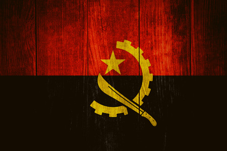 flag of Angola or Angolan banner on wooden backgroundの写真素材