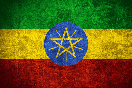 flag of Ethiopia or Ethiopian banner on scratched vintage textureの写真素材