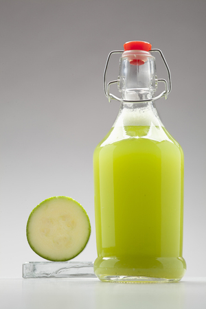fresh green vegetable  juice, bottle of smoothie on white backgroundの写真素材
