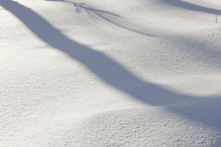 snow texture with ligthbeams and shadows, white backgroundの写真素材