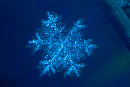 These snowflakes shot in super macro winter frost. Background for christmas gifts and new year, bright winter beautiful snowの写真素材