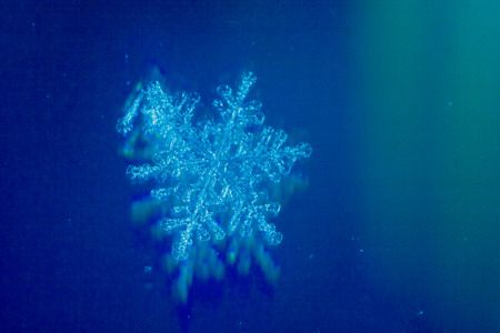 These snowflakes shot in super macro winter frost. Background for christmas gifts and new year, bright winter beautiful snowの写真素材