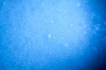 background of the fresh snow with snowflakes. winter backgroundの写真素材