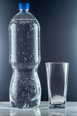 bottle of clear drinking cold mineral water with gas, isolated on backgroundの写真素材