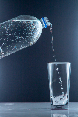 bottle of clear drinking cold mineral water with gas, isolated on backgroundの写真素材