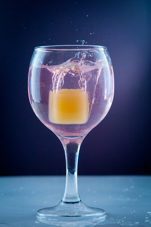 Fruit orange ice in a glass of cold refreshing clean drinking waterの写真素材