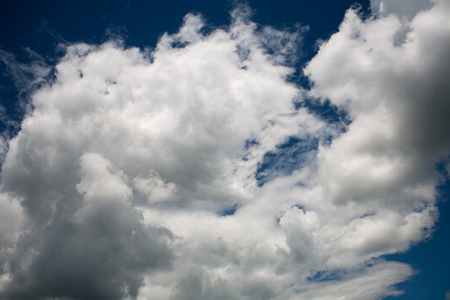 Beautiful white clouds on a blue cloudy sunny sky rain clouds from water vapor in the atmosphereの写真素材
