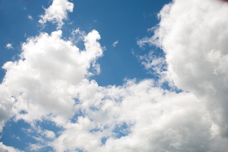 Beautiful white clouds on a blue cloudy sunny sky rain clouds from water vapor in the atmosphereの写真素材