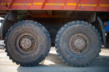 Wheel of large truck and trailers. Big wheels in mud and sandの写真素材